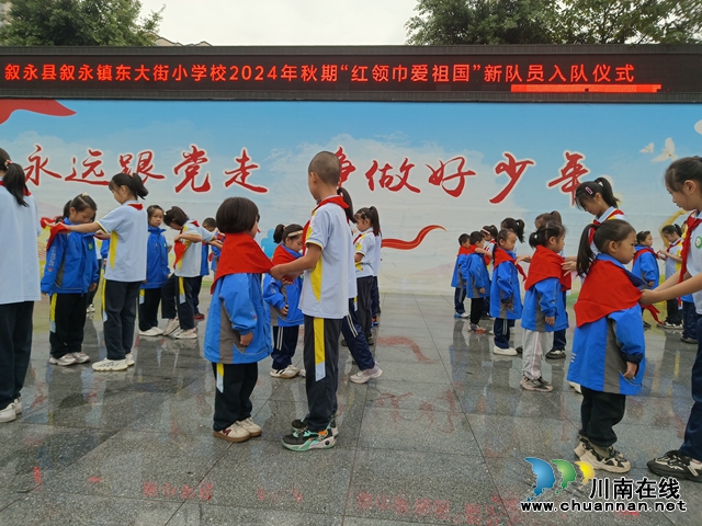 红领巾爱祖国 | 东大街小学举行2024年秋期少先队新队员入队仪式(图1) 老队员为新队员佩戴红领巾.jpg