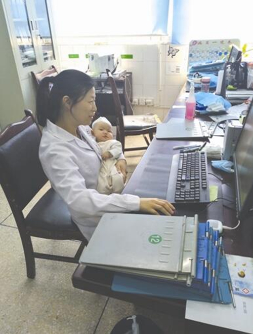 一手抱患儿一手写病历 儿科女医生当临时妈妈(图1) 一手抱患儿一手写病历 儿科女医生当临时妈妈(图1)